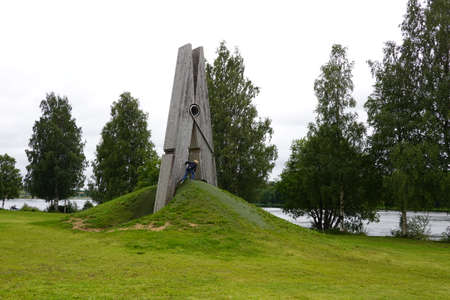 Big clothespin in a park with green grassの写真素材