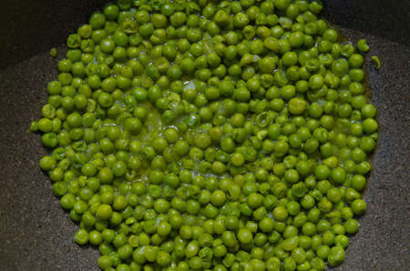Peas with onion in a potの写真素材
