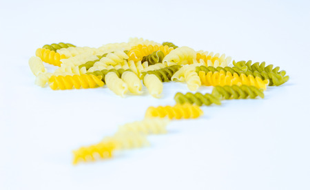 Uncooked macaroni isolated on white backgroundの写真素材