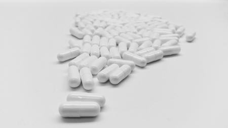 White capsules in the pharmacy laboratory isolated on white backgroundの写真素材