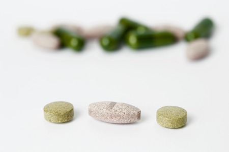 Tablets and capsules in the pharmacy laboratory isolated on white backgroundの写真素材