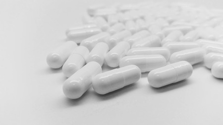 White capsules in the pharmacy laboratory isolated in white backgroundの写真素材