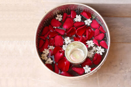Water with rose petal and jasmine in silver bowlの写真素材