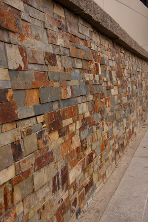 Grey, white and brown granite brick wall perspectiveの写真素材