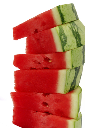 stack of red watermelon slices on white backgroundの写真素材