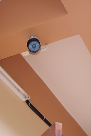 security camera on a ceiling of a houseの写真素材