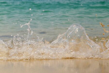 Wave washing up onto sand beach.の写真素材