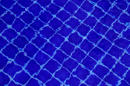 Background of water in the swimming pool with a wave.の写真素材