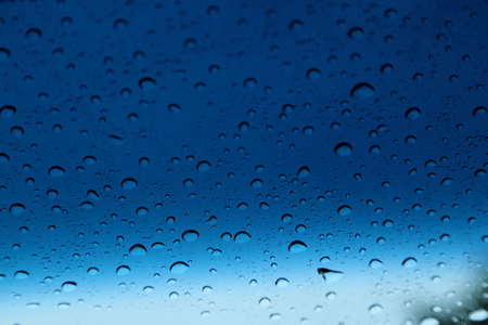 Raindrops on glass, abstract background.の写真素材
