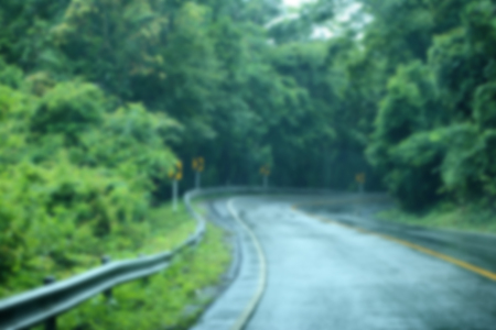 Blurred wet road in the forest after rain.の写真素材