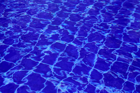 Background of water in the swimming pool with a wave.