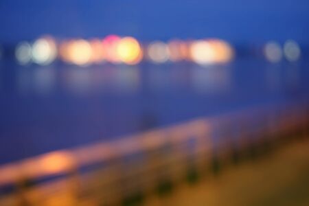 Blurred bokeh of night light at riverside.の写真素材