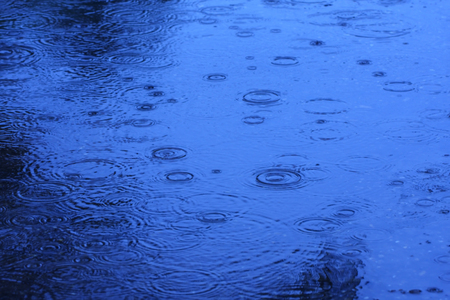 Abstract blur background of raining flow down on the floor, blue tone.の写真素材