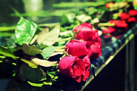 Red rose bouquet laying on mable shrine, vintage style process.の写真素材