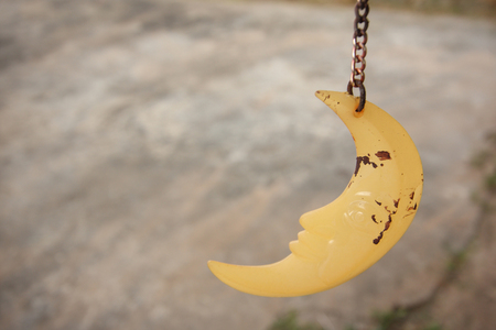 Grungy moon hanging on string as mobile home decoration.の写真素材