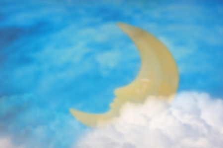 Blurred scene of sleeping moon on white cloud with night sky background.の写真素材