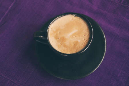Coffee cup on breakfast table, vintage warm color tone.の写真素材