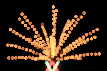 Defocused bokeh lights as radius line on black background.