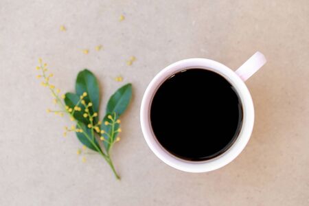 Confectioners atmosphere concept. Cup of black coffee on wood background, seen from top.の写真素材