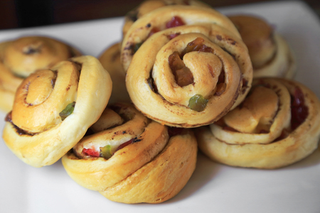 Sweet bun roll swirl breads with dried fruit and cinnamon.