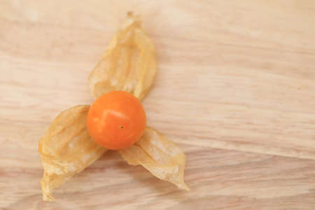 Cape gooseberry, autumn fruit on brown wooden background.の写真素材