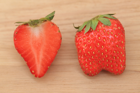 Fresh strawberry full body and half on wooden background.の写真素材