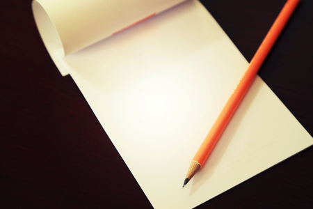 Pencil laying on blank note paper, Creative work, writing, drawing concept. Vintage toned mood.の写真素材