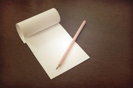 Pencil laying on blank note paper, Creative work, writing, drawing concept. vintage toned with paper textures image.の写真素材