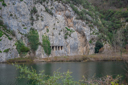 Rocky cliff with ancient rock tombs of Asarkale in Bafra, Samsun, Turkey. Historical ancient columns carved into the rock. Tourist attractions, tour destinationsの写真素材