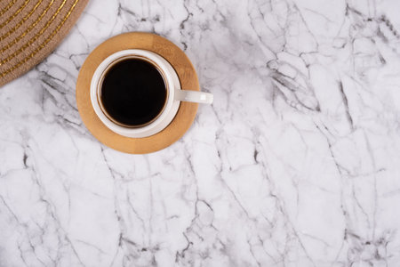 Black coffee, top view of coffee cup on marble texture background. Flat lay, breakfast concept, copy...