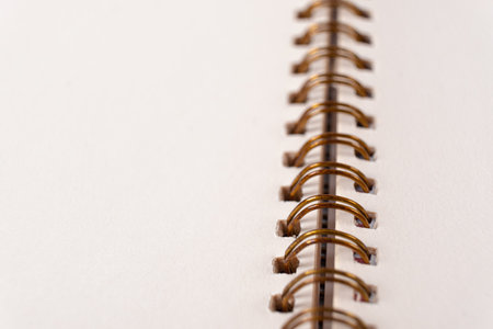 Blank spiral bound notebook. Close-up of blank paper notebook in a binder with metal ring binding, macro, real photoの写真素材