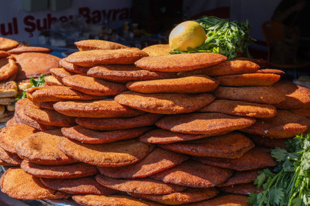 Traditional Turkish Stuffed Meatballs (Kibbeh) at a Market. Golden Brown Heap of Kibbeh for Sale at a Bazaar. Turkish Dish, cuisine. Street foodの写真素材