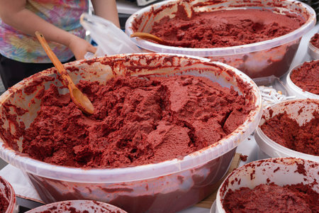 Homemade Tomato Paste in Large Containers. Traditional Fresh Tomato Paste for Sale at a Marketの写真素材