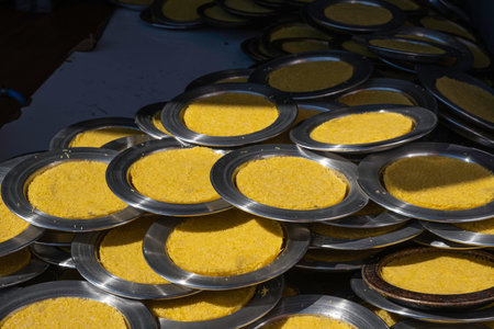 Traditional Turkish and Arabic dessert knafeh, kunefe. Delicious kunafa on copper tray plates. Middle eastern sweet sheese pastry. Kadaif, knafeh pastry cooked on the stove.の写真素材