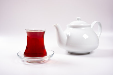 Cup of tea and teapot, a cup of tea and porcelain teapot isolated on a white backgroundの写真素材