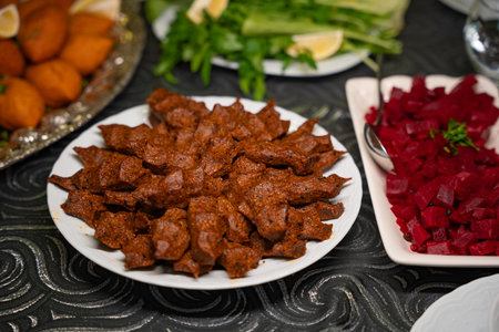 Plate of traditional kofte served with beet salad, greens and lemon slices. Traditional middle eastern and turkish cuisine kibbeh. Spicy bulgur meatballs.の写真素材