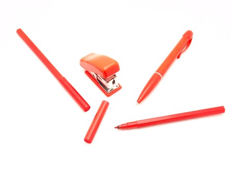 Reds a stapler, the handle and a felt-tip pen on a white background     の写真素材