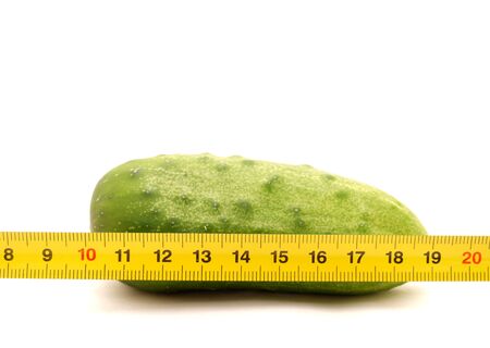 Cucumbers and ruler on a white background        の写真素材