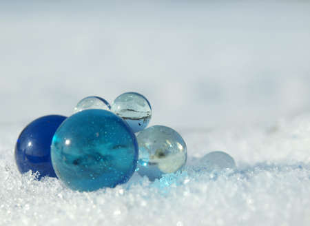 Blue and transparent balls on a snow in the winter         の写真素材