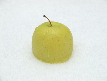 Green apple on a snow      の写真素材