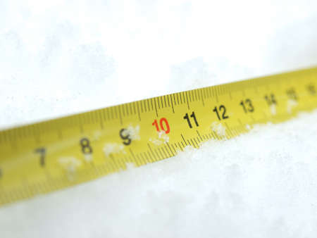 Measuring tape on a snow in the winter         の写真素材