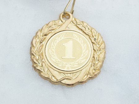 Gold medal on a snow    の写真素材
