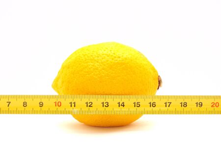Lemon and ruler on a white backgroundの写真素材