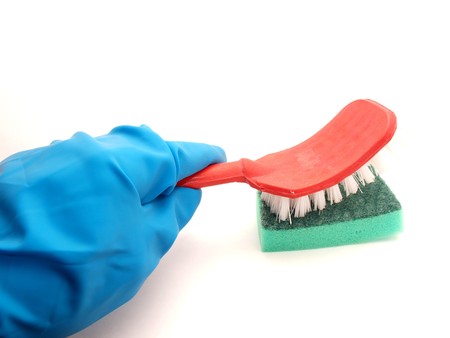 Rubber glove and brush on a white background       