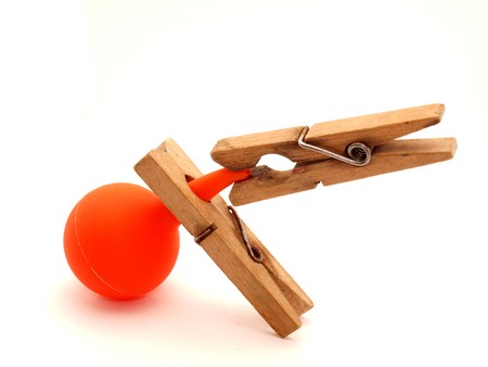 Red syringe and clothespin on a white background          の写真素材