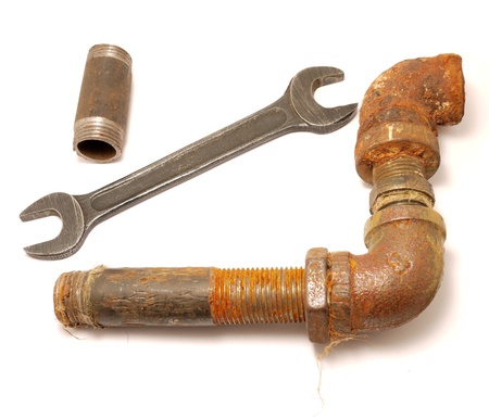 Old a pipe and a wrench on a white background の写真素材