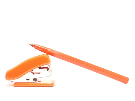 Stapler and a felt-tip pen on a white background の写真素材