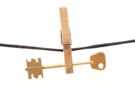 Key, clothespin and rope on a white backgroundの写真素材