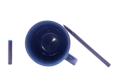 blue cup and felt-tip pen on a white backgroundの写真素材