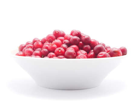 cranberries in a bowl on a white backgroundの写真素材